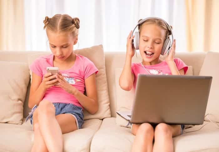 middle school twin girls on couch