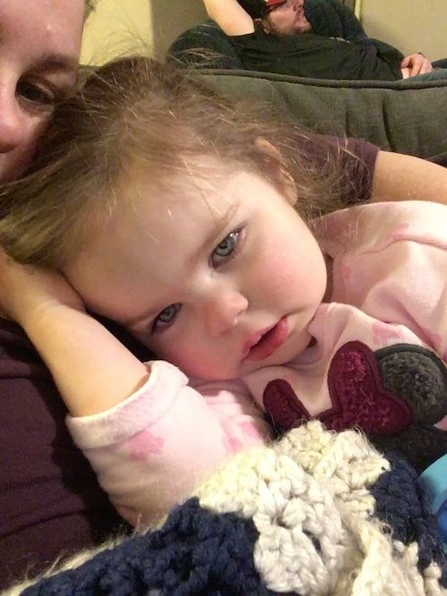 little girl snuggled up with mom cold and flu season