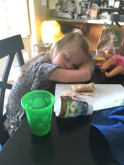 little girl fell asleep at the table cold and flu season