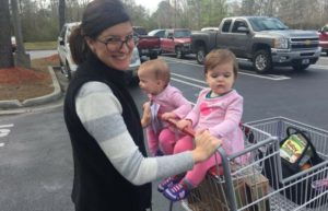 Mom pushing twins in cart