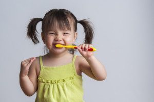girl brushing teeth oral care routine