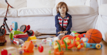 boy sitting on floor with toys kids toys