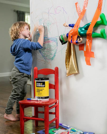 boy drawing on wall after school messes