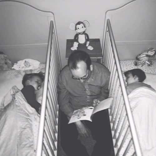 dad reading between cribs twin dads