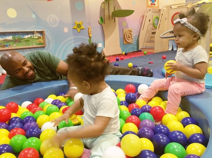 dad with twin girls in ball pit twin dads