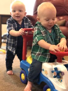 twin boy toddlers playing with ride on car stay-at-home parents of twins