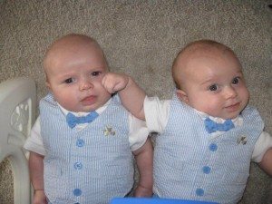 infant twins in matching suits