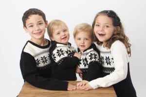 twin toddlers and two older children in matching sweaters