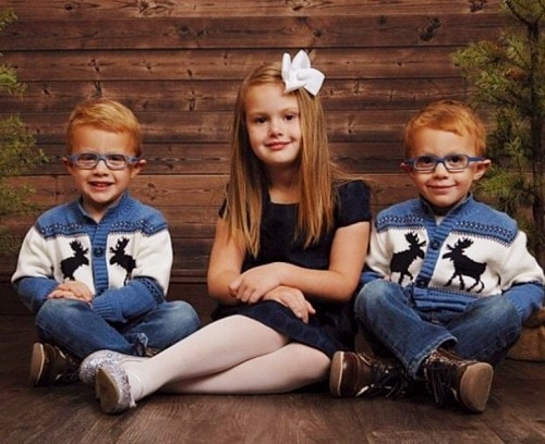 three kids sitting on floor w-sitting